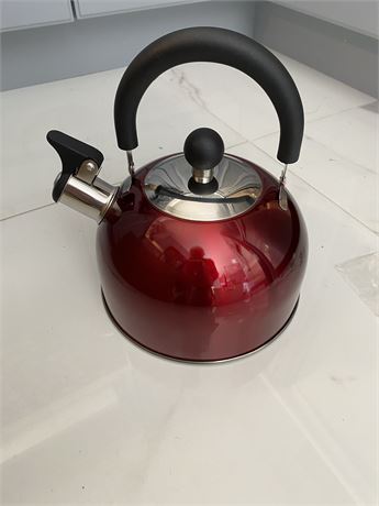 Red stovetop whistling tea kettle